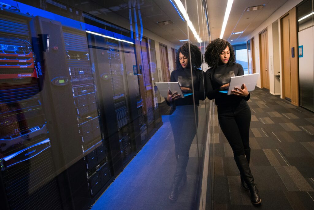 a woman standing standing beside a data center